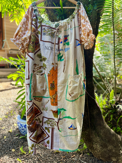 Vibrant one size, plus size smock to suit many different bodies, size inclusive, vintage patchwork smock hanging in a beautiful spring fashion garden