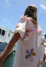Load image into Gallery viewer, Person wearing a one size, plus size, bohemian white dress with colourful flower applique standing on a boat docked at a pier. Great Christmas Dress and black friday sale